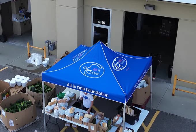 The All is One Foundation tent from above, set up with fresh produce