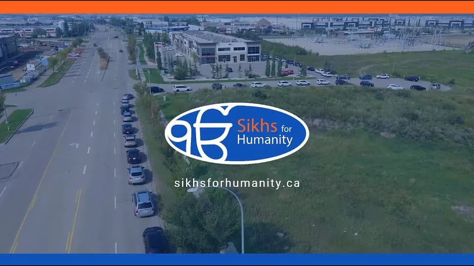 Aerial view of a long line of cars waiting along Roper Road for the All Is One Food Bank